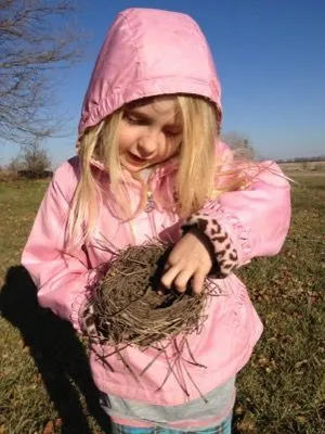 Portrait of a girl playing with nest